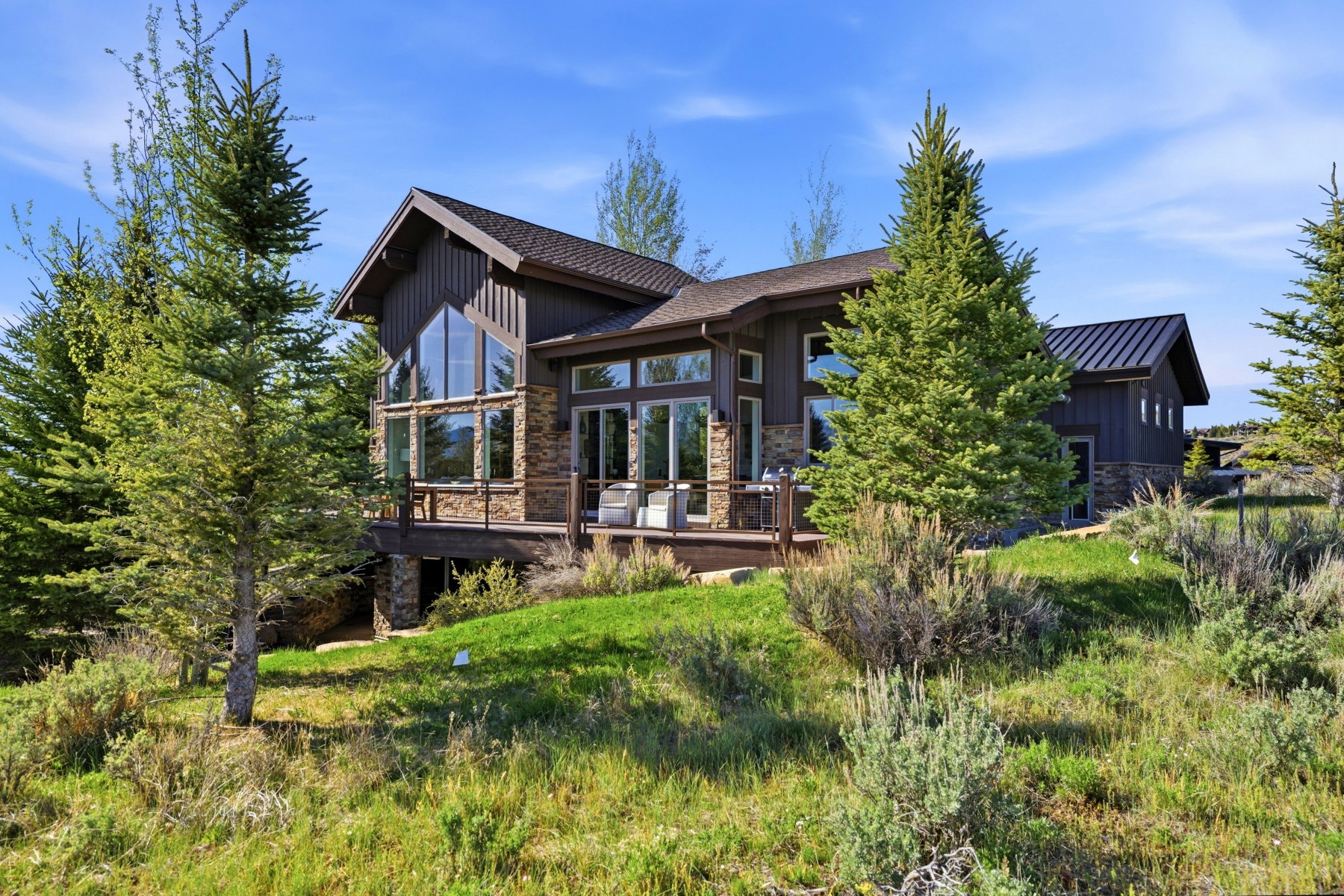 Contemporary exterior featuring wood-finish siding and stone accents