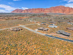 Aerial view of sparsely populated area featuring a mountain backdrop and a desert landscape