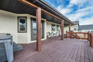 Wooden terrace featuring area for grilling