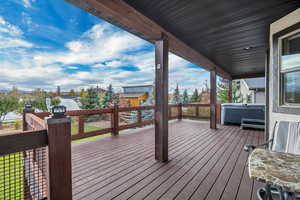 Wooden deck with a hot tub and a residential view