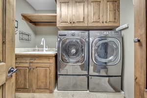 Laundry area with cabinet space and washing machine and dryer