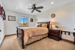 Bedroom with recessed lighting, light colored carpet, and ceiling fan