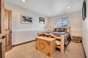 Bedroom featuring light colored carpet and recessed lighting