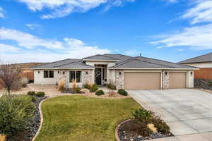 Prairie-style house with stucco siding, stone siding, concrete driveway, an attached garage, and a tiled roof