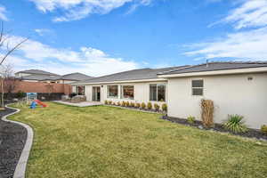 Rear view of property with a patio area and stucco siding