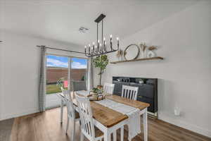 Dining space featuring light wood finished floors and hanging lights