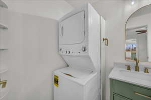 Laundry area with stacked washing machine and dryer
