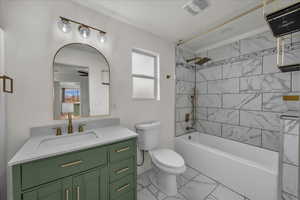 Bathroom featuring shower / washtub combination, vanity, and light marble finish floors