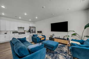 Living room with dark wood-style floors and recessed lighting