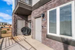Doorway to property featuring stone siding