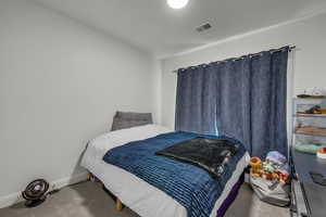 Carpeted bedroom with baseboards