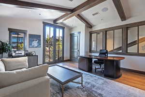 Office with french doors and beam ceiling