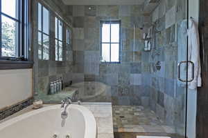 Full bathroom with a whirlpool tub and tiled shower