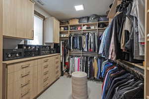 Walk in closet with light carpet
