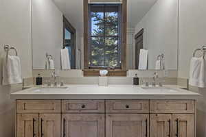 Full bath featuring double vanity