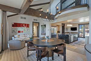 Dining room featuring light stone finish flooring and vaulted ceiling