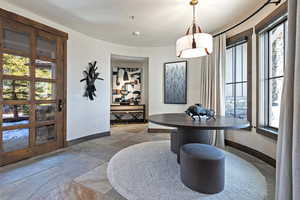 Dining room with stone tile floors and baseboards