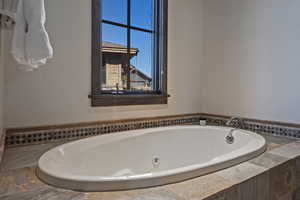 Full bath featuring a jetted tub