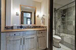 Bathroom featuring tiled shower / bath combo and vanity