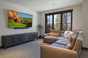 Living area featuring carpet and baseboards