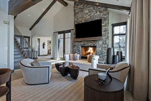 Living area featuring a stone fireplace and stone finish flooring