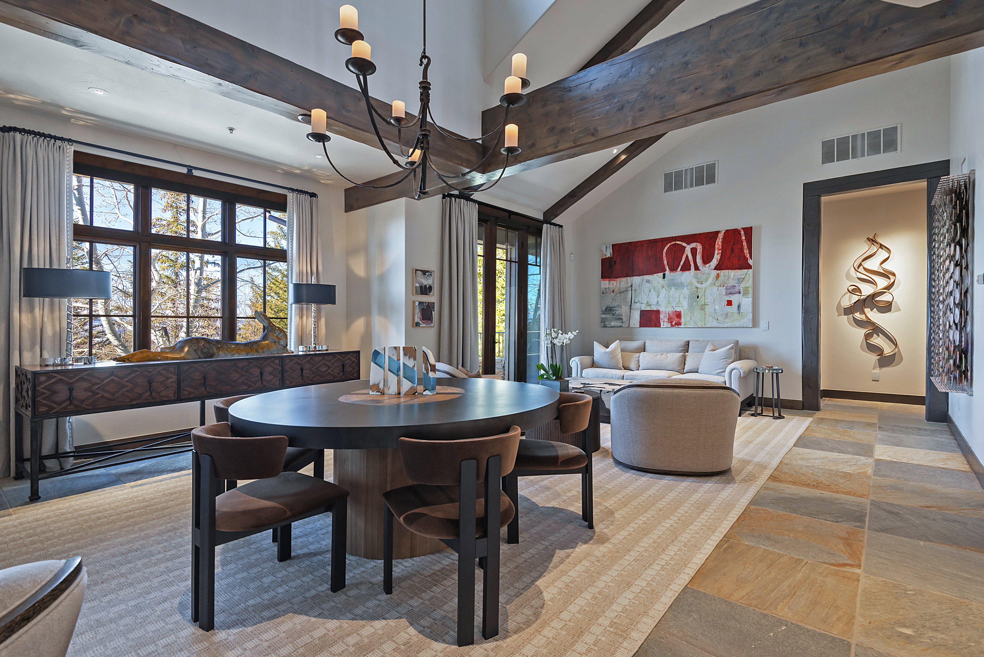 Dining area featuring lofted ceiling and baseboards