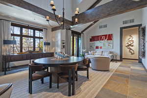 Dining area featuring lofted ceiling and baseboards