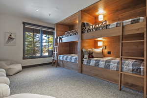 Bedroom with carpet flooring and wooden walls