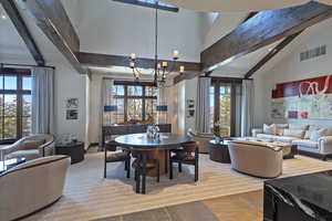 Dining space featuring vaulted ceiling and suspended lighting