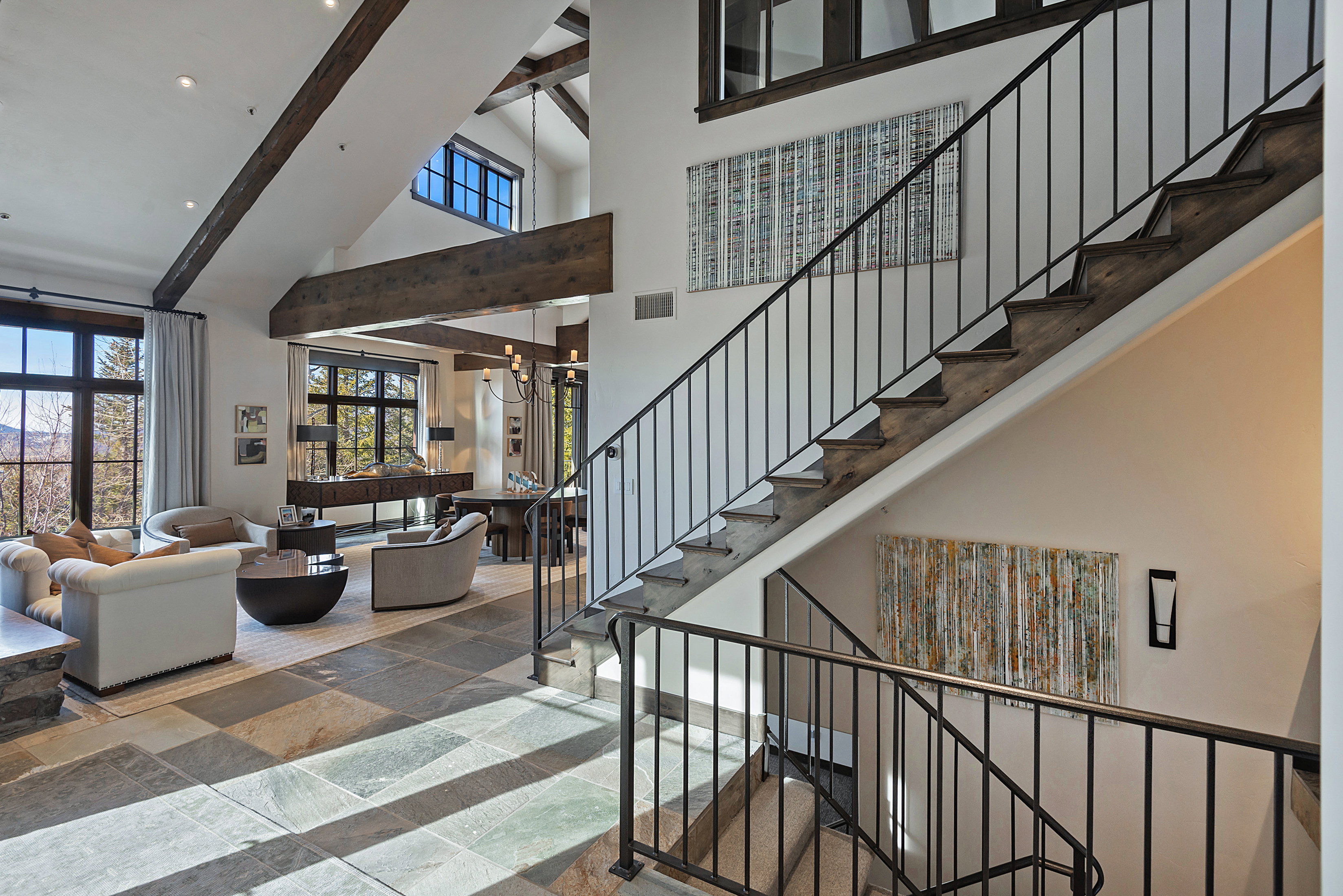 Stairway with stone tile floors and recessed lighting
