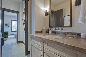 Bathroom featuring stone tile flooring and vanity