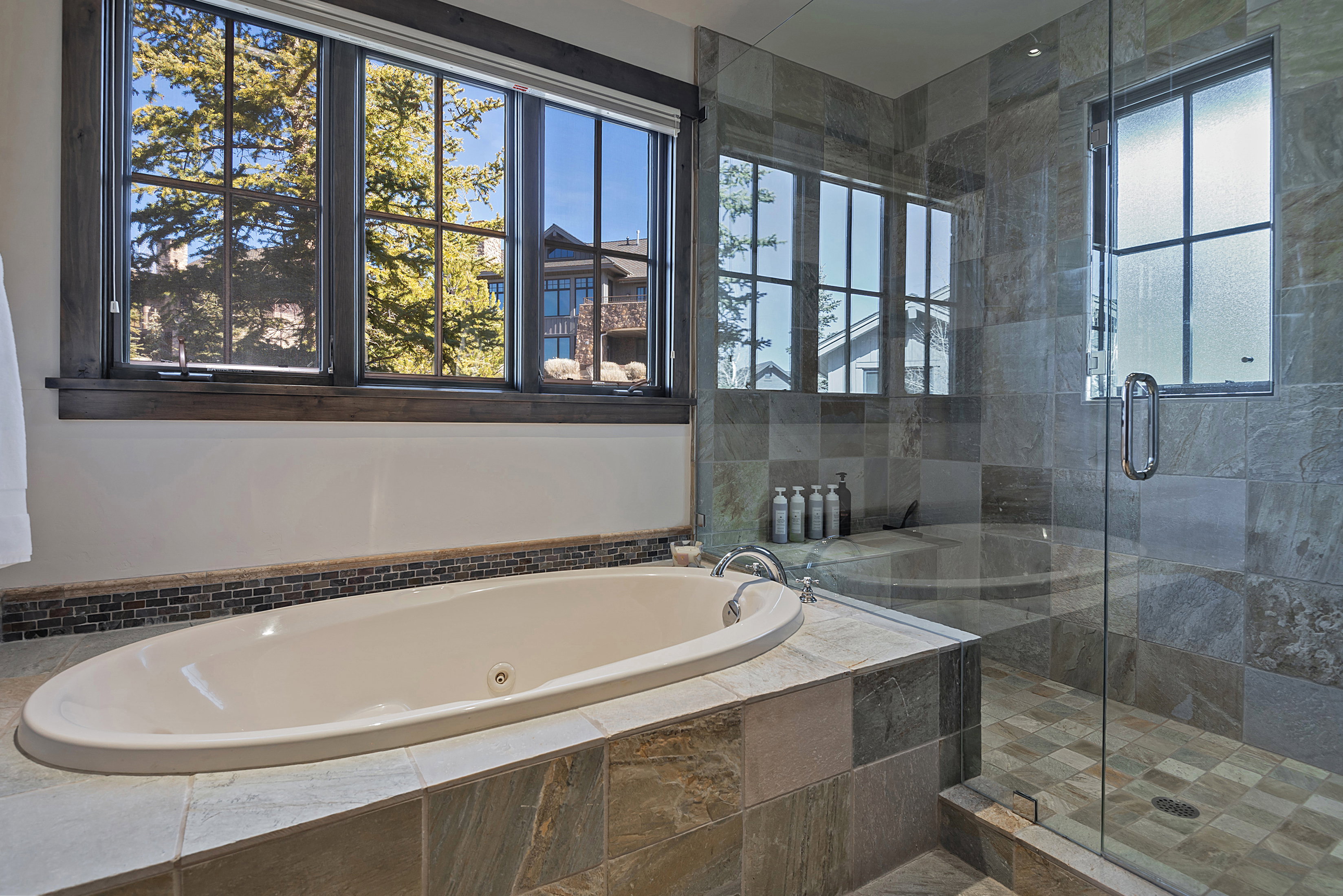 Bathroom with a whirlpool tub and a shower stall