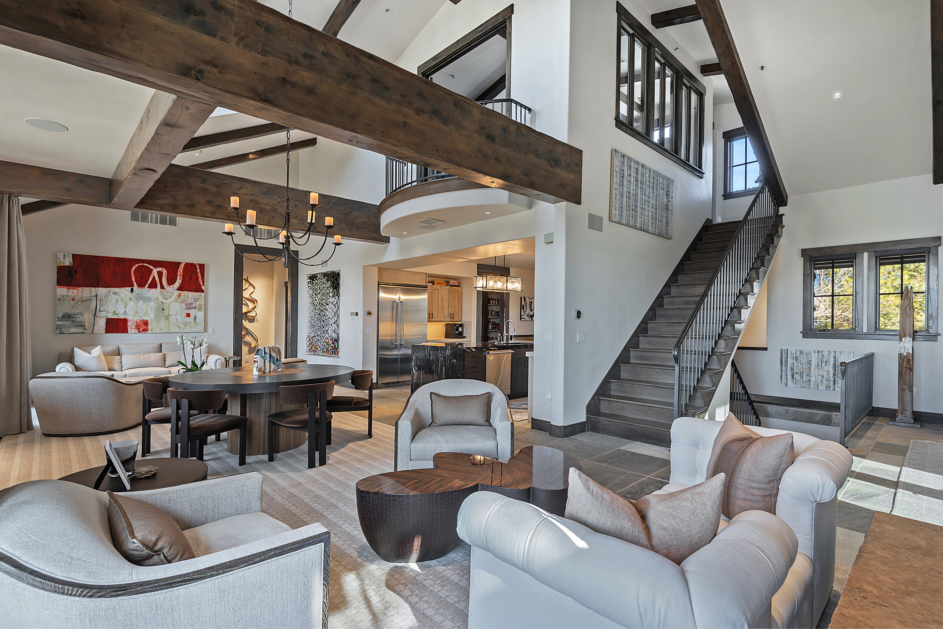 Living area with suspended lighting and vaulted ceiling