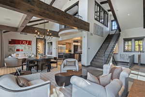 Living area with suspended lighting and vaulted ceiling
