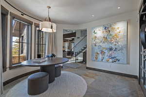 Dining area featuring stone tile flooring and recessed lighting