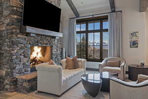 Living area featuring a fireplace and beam ceiling