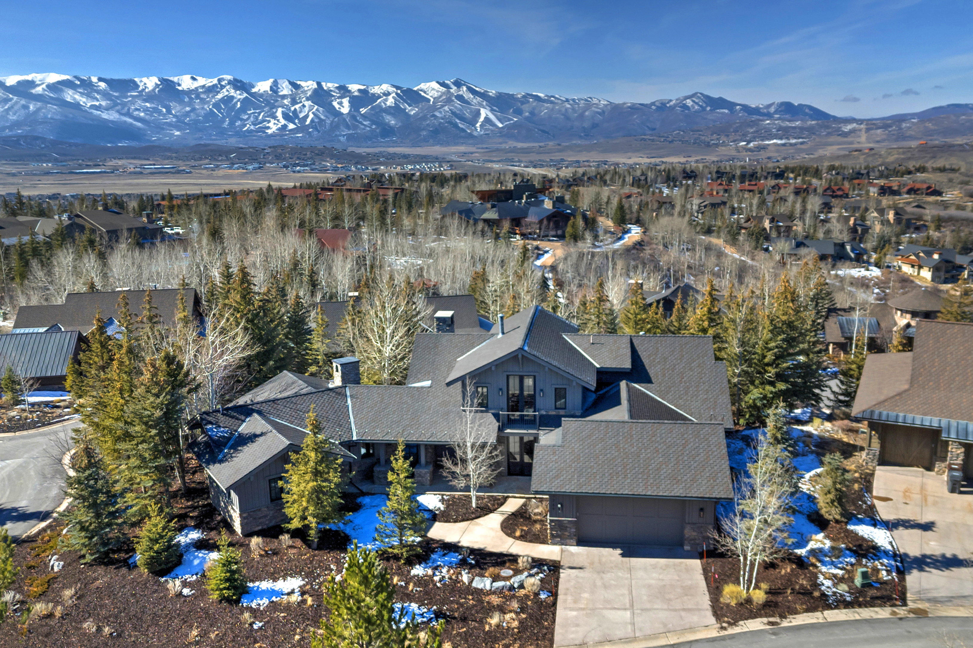 Aerial perspective of suburban area with a mountainous background
