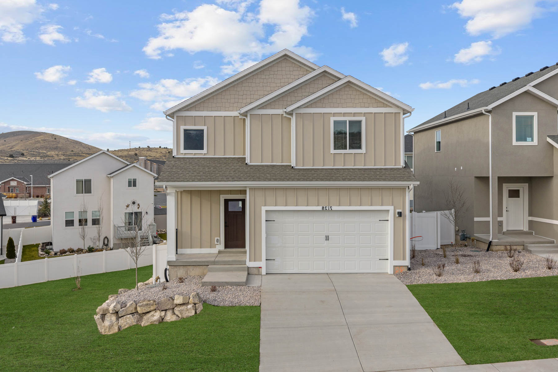 Two-story exterior with light beige siding and white trim