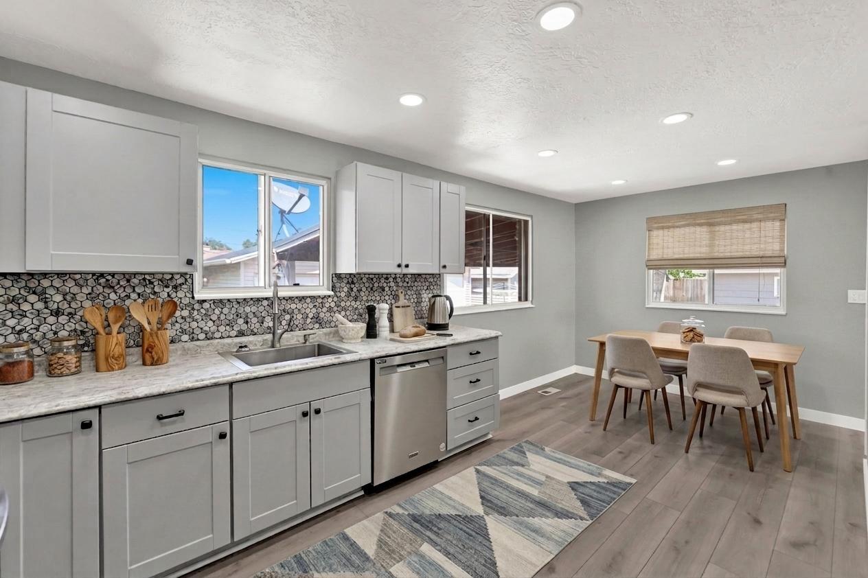 Modern kitchen featuring light gray cabinetry.  Virtually staged to illustrate the home's potential.