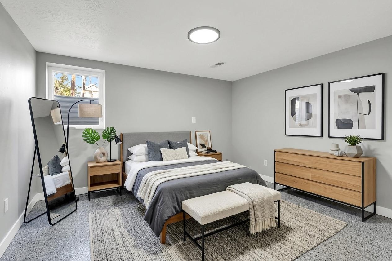 Bedroom featuring light gray walls, a window, and a flush-mount ceiling light. Virtually staged to illustrate the home's potential