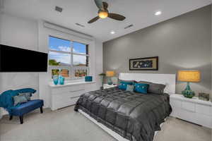 Carpeted bedroom with ceiling fan and recessed lighting