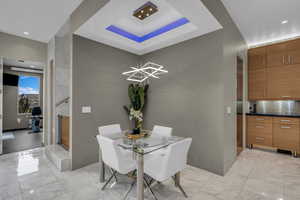 Dining room with a raised ceiling and recessed lighting