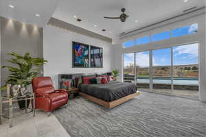 Bedroom with access to outside, recessed lighting, a ceiling fan, and a high ceiling