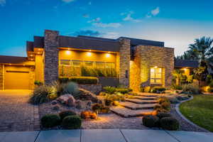Contemporary home with stone siding and stucco siding