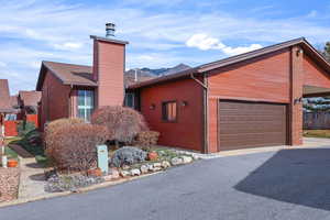 View of front of house,chimney and an attached garage New Roof