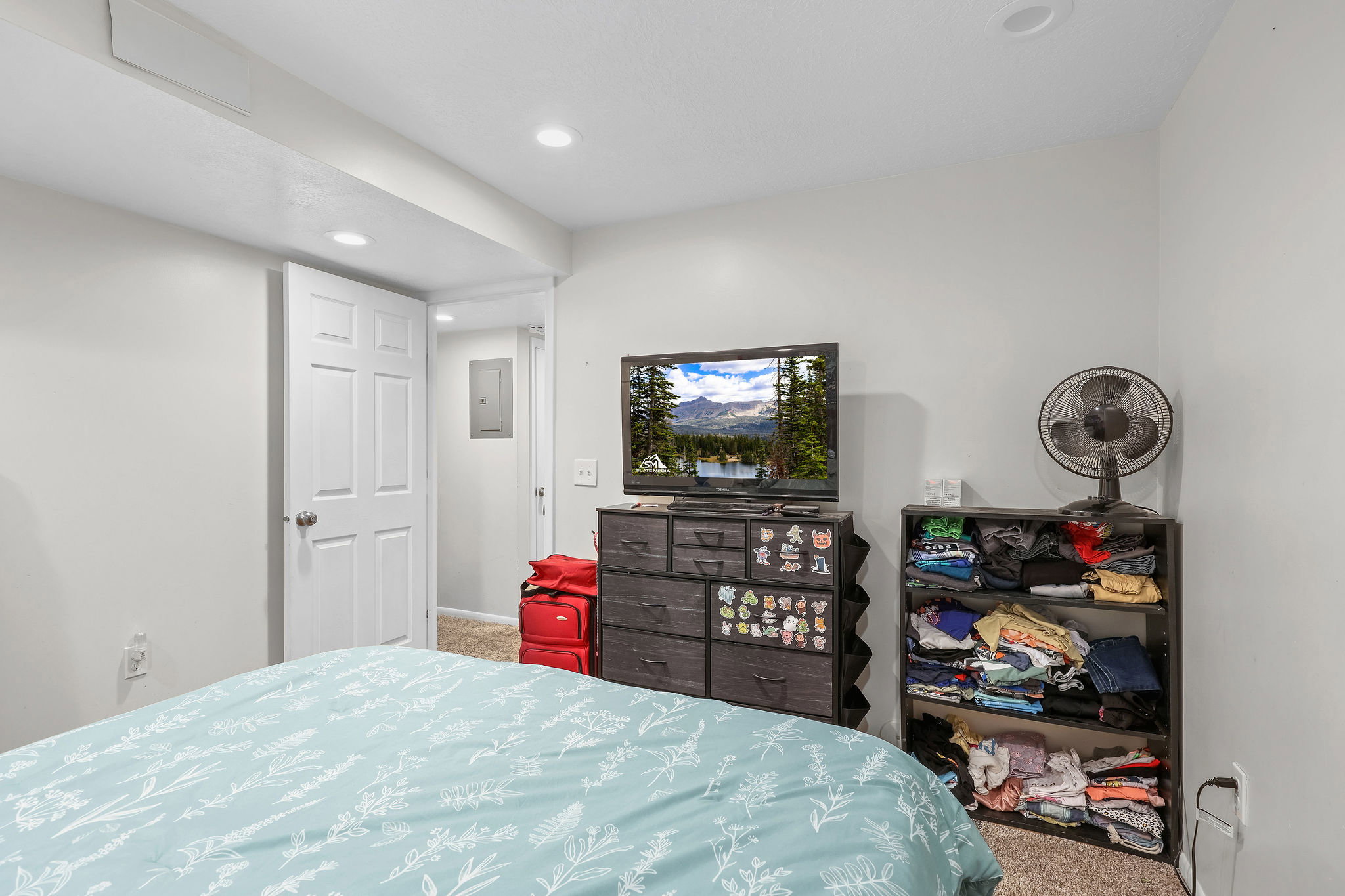 Bedroom with carpet flooring, recessed lighting, and electric panel