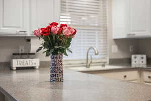 Kitchen view of white cabinetry and light  counters