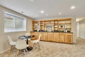 Dining space featuring light carpet and recessed lighting