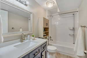 Full bathroom featuring vanity, shower / tub combination, and light wood-style flooring