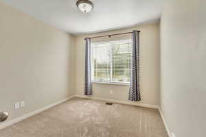Carpeted empty room with baseboards